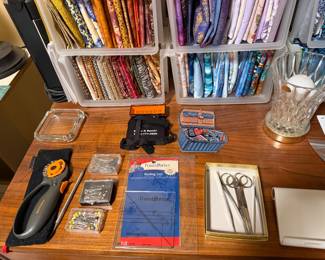 Rotary cutter, rulers, scissors and notions on a work table