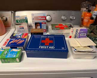 First aid kit and household supplies on a dryer