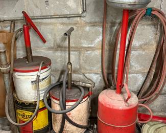 Grease guns and fluid pumps on a garage wall