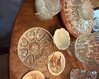 Pressed glass plates, bowls and serving pieces on a table
