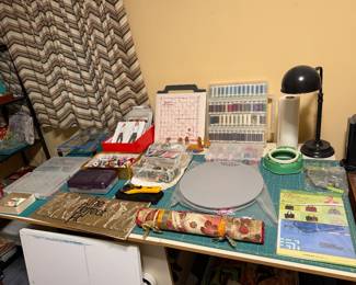 Sewing station with thread racks, cutting mat and notions