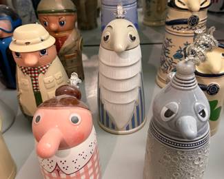 Figural character steins with animal and figure lids