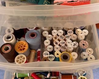 Bins of thread cones and wooden spools