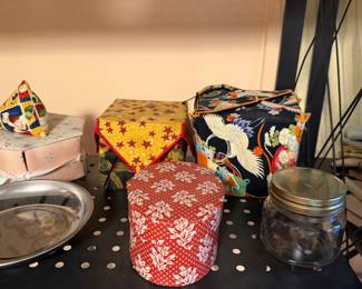 Handmade fabric storage baskets and a glass jar