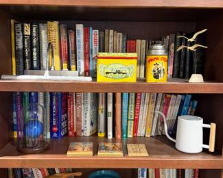 Bookshelf with vintage lunch boxes and paperbacks