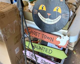 Halloween decorations including a cat cutout and signs