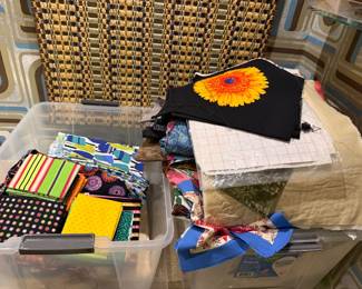 Bins of fabric and a sunflower print panel