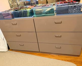 Storage drawers with bins of fabric and supplies on top