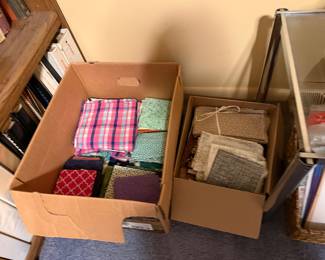 Boxes of folded plaid and homespun fabric