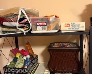 Shelf with sewing supplies and a bin of folded fabric