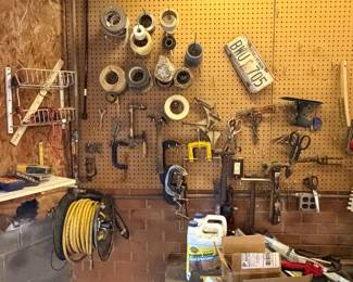 Pegboard wall of hand tools and clamps