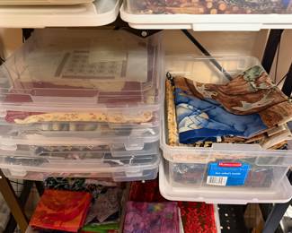 Clear bins of quilting cotton and project pieces