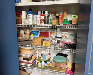 Pantry shelves of craft paints and bottles