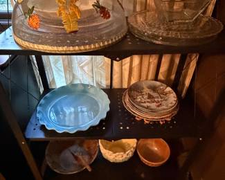 Shelves with glass bowls, trays and decorative plates