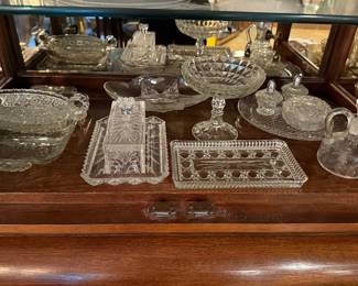 Pressed glass serving dishes in a display cabinet