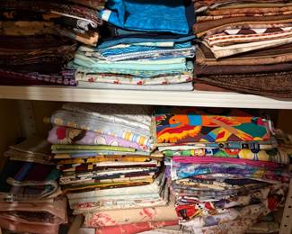 Shelves of folded fabric in blues and brights