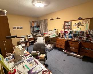 Sewing room with machines, cutting table and fabric storage