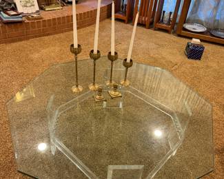 Glass top table with a brass candelabra