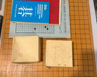 Go board with stones and Go reference books