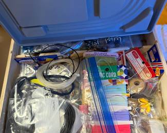 Bin of craft supplies, cords and project materials