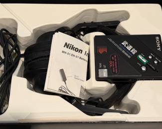 Nikon and Sony camera accessories with strap and manual