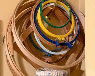 Stack of wooden and plastic quilting hoops in several sizes