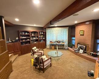Living room with built in shelving and brick fireplace wall