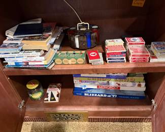 Shelves of paperback books and boxed games