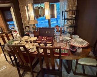 Dining room table set with glassware and serving pieces