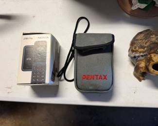 Pentax camera accessories and a remote in a case
