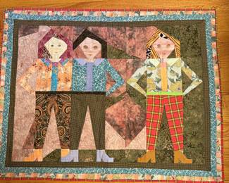 Handmade applique quilt with three children in patchwork clothing