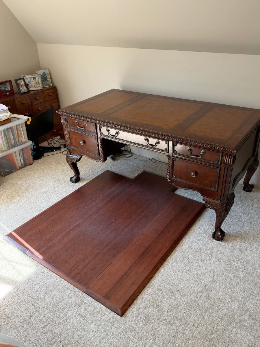 Sligh carved executive desk — desk only; loose floor panel and surrounding items are not confirmed inclusions.