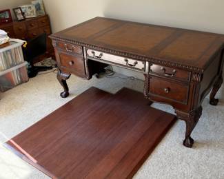 Sligh carved executive desk — desk only; loose floor panel and surrounding items are not confirmed inclusions.