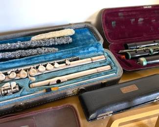 Vintage CG Conn silver plated flute with case (L); Antique German wooden flute (R); Hartley piccolo with case (front)