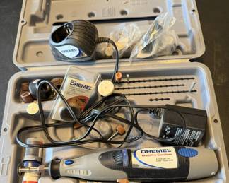 Dremel MultiPro Cordless rotary tool kit, featuring model 780 9.6V tool, charger, base, and various grinding and cutting accessories in original hard plastic case.