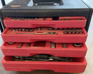 Vintage Craftsman molded plastic mechanic's tool chest featuring four slide-out red organizer trays filled with assorted sockets, ratchets, and hand tools.