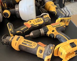 Collection of used DeWalt 20V Max cordless power tools, including an oscillating multi-tool, drill driver, and reciprocating saw.