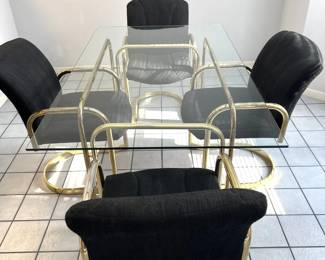 Vintage 1980s brass dining table with rectangular glass top and four matching brass cantilever armchairs with black upholstered seats.