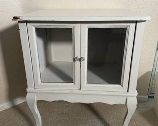 White curio cabinet with glass doors and curvy French style legs. Show off your treasures.