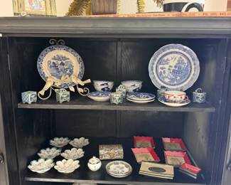Black hutch loaded with Blue Willow china, teacups and dainty dishes. Tea party, anyone?
