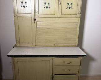 Antique Hoosier style kitchen cabinet with hand stenciled doors, tambour roll and enamel work top. Grandma's kitchen command center and the star of the show.