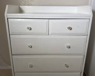 White chest of drawers with sparkly glass knobs.