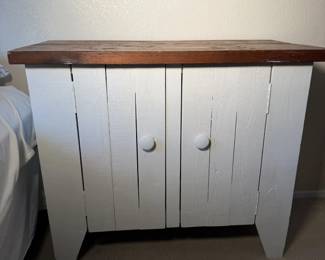 Rustic white plank cabinet with a stained wood top. Farmhouse chic.