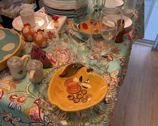 Colorful dishes, pitchers, glassware and cheery serving bowls. Set the table for a party.