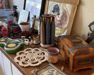 Vintage wooden box, crocheted doilies, wooden spools and framed art. Grandma's craft corner at its finest.