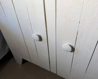 Plank doors with chunky round knobs.