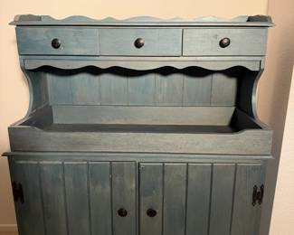Blue painted dry sink style cabinet with a scalloped top and plank doors. Farmhouse goodness.