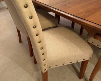 Linen look dining chairs with brass nailhead trim. Comfy and classy.