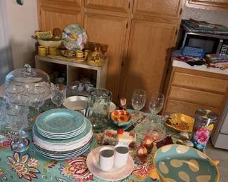 Kitchen table spread: cake stands, glassware, teal dinner plates and fun serving pieces.