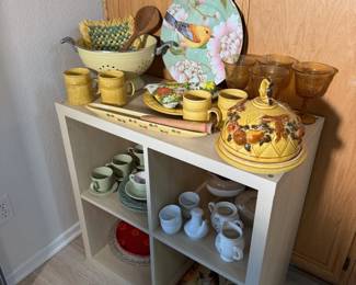 Another look at the pottery shelf: bird platter, colander, amber glasses and sunny yellow ware.